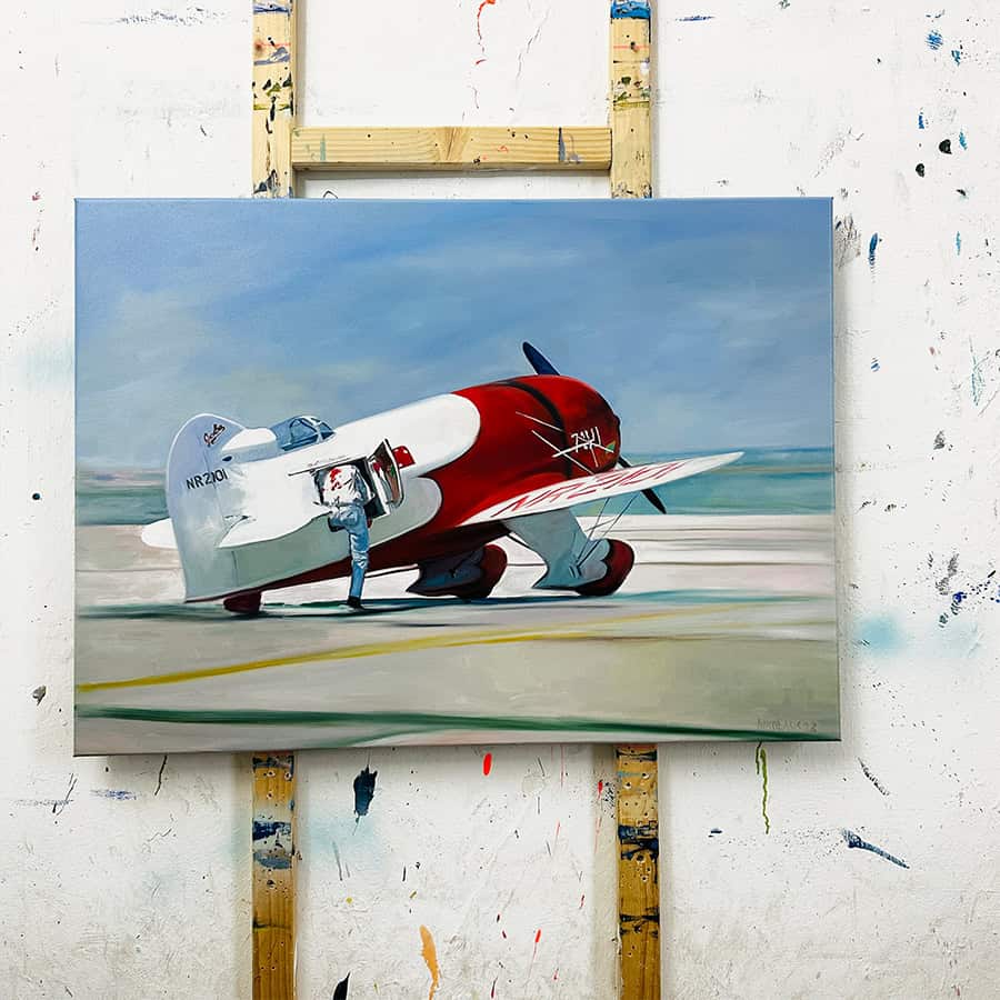 Jet Artist Artwork. A detailed painting of a vintage jet aircraft on display, showcasing realistic colors and shading with a blue sky background, created by commissioned artist Nikolaus Kriese.