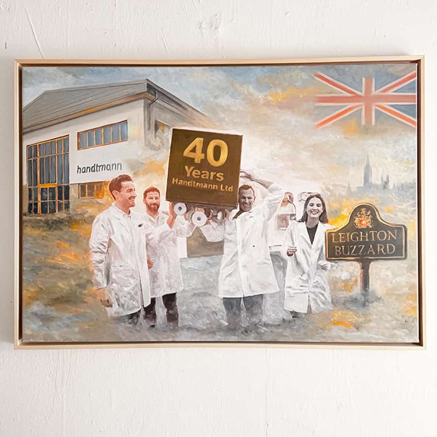 Handmade painting depicting workers holding a sign for 40-year anniversary, set outside a factory with Union Jack flag and company sign, showcasing dedication and craftsmanship.