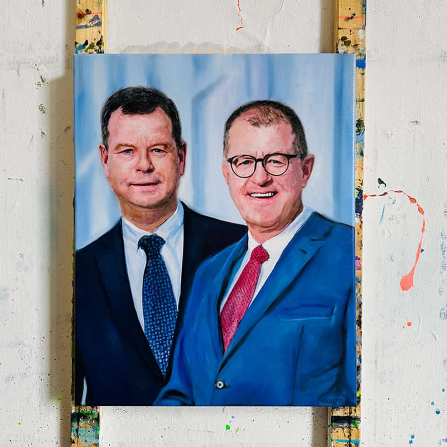 Custom Portrait Painting of two men in suits by Nikolaus Kriese, showcasing detailed realism and vibrant colors, suitable for international shipping.