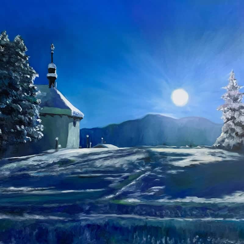 Serene winter night scene featuring a church with a snow-covered roof, illuminated by moonlight, surrounded by snow-laden trees and distant mountains under a clear, starry sky.