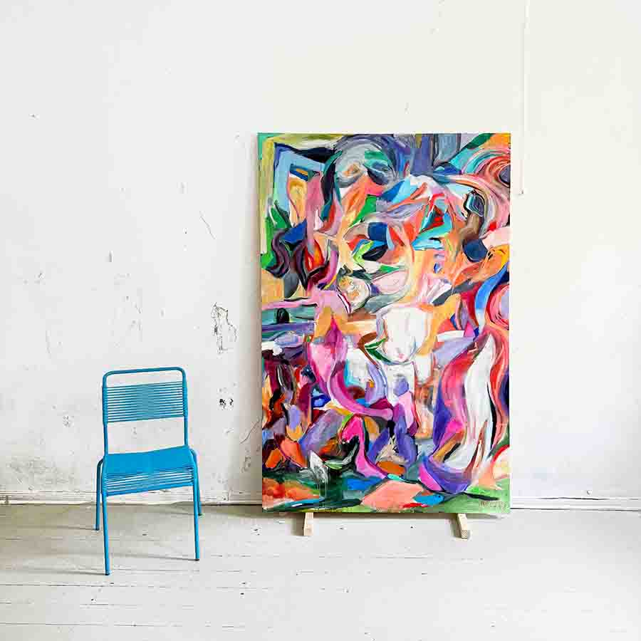 A vibrant, abstract painting by Nikolaus Kriese displayed on an easel against a white wall, with a blue chair nearby, showcasing contemporary art available for international shipping.
